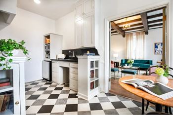 a kitchen and living room with a checkered floor at Villa Carlotta – Furnished Apartments, Los Angeles, 90028